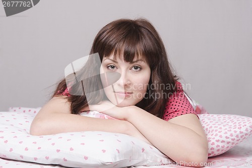 Image of The young beautiful girl lying in bed