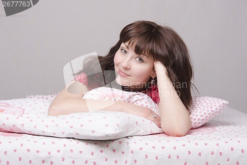 Image of Happy girl lying in bed