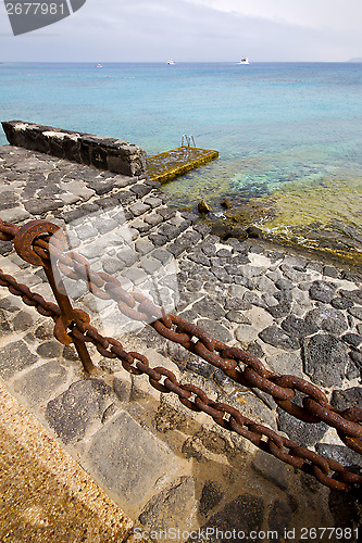 Image of pier rusty chain  water  in lanzarote 