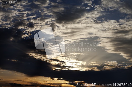 Image of Dark clouds and sunrise at evening sky