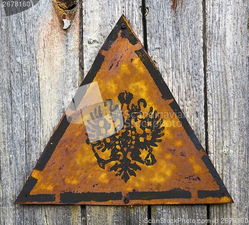 Image of Russian Double Eagle on Rusty Warning Sign.