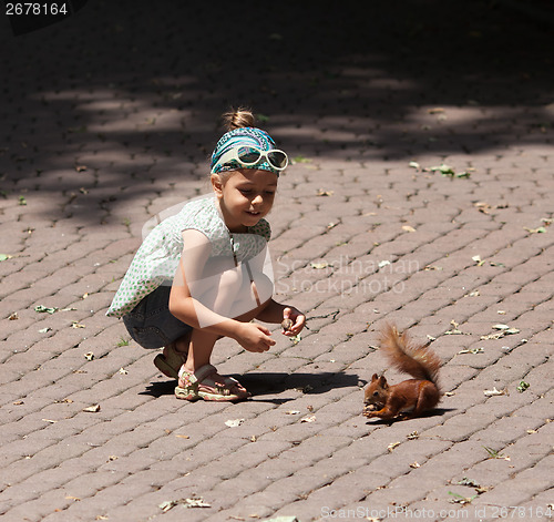 Image of Little girl and squirrel