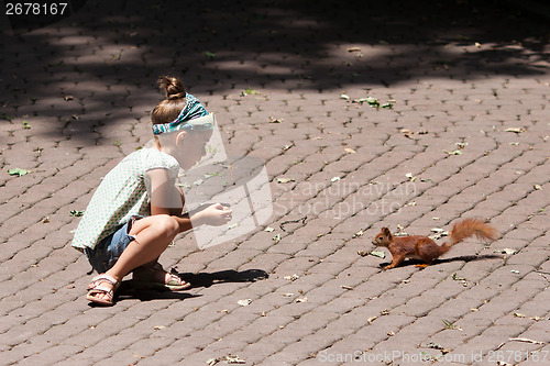 Image of Little girl and squirrel