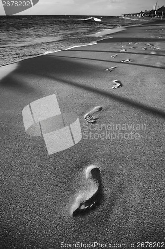 Image of Footprints in sand beach black and white