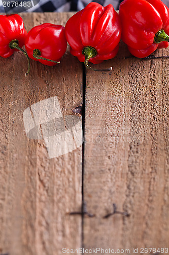 Image of Red chili peppers on wooden board