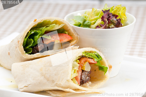 Image of kafta shawarma chicken pita wrap roll sandwich