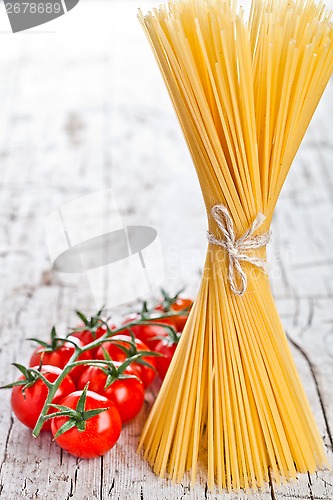 Image of uncooked pasta and fresh tomatoes
