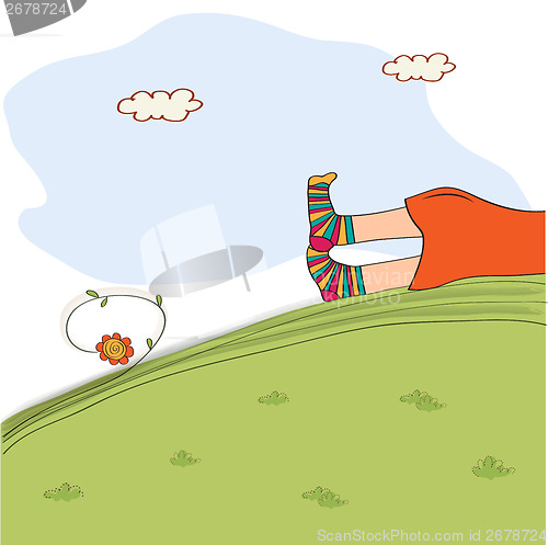 Image of bored girl legs lying on the grass