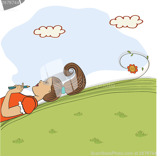 Image of bored young girl lying on grass