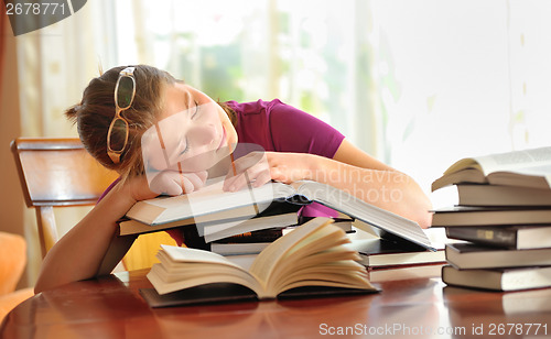 Image of teenager girl sleeping on books