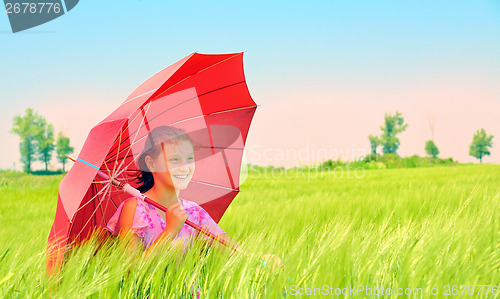 Image of Girl with umbrella at field