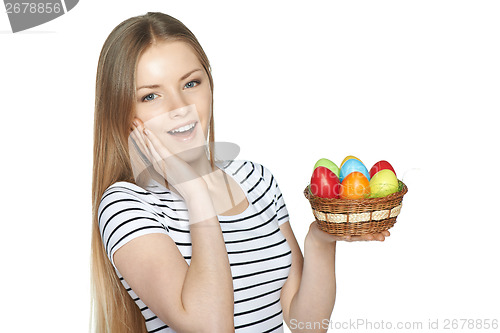 Image of Surprised female holding basket with Easter eggs