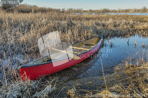 Image of red canoe in a wetland