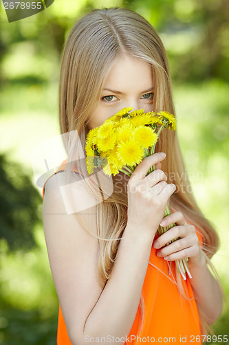 Image of Girl smelling bunch of dandelions