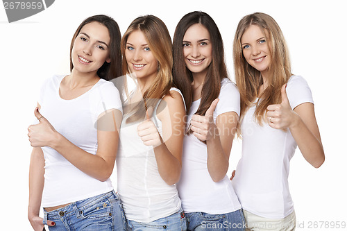 Image of Happy group of friends gesturing thumbs up