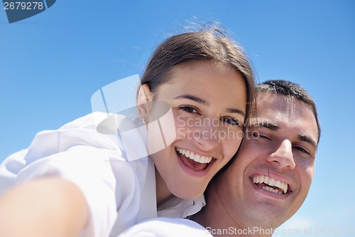 Image of happy couple have fun on the beach