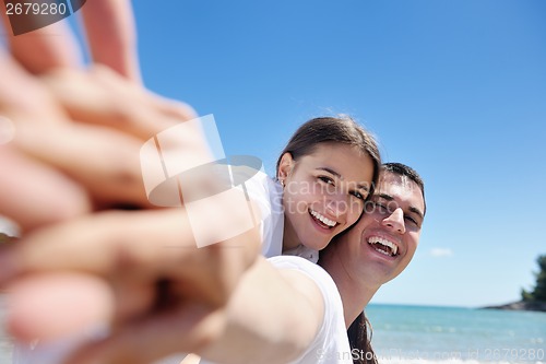 Image of happy couple have fun on the beach