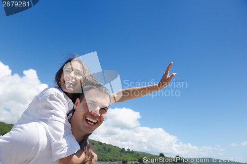 Image of happy couple have fun on the beach