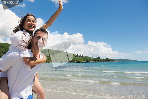 Image of happy couple have fun on the beach