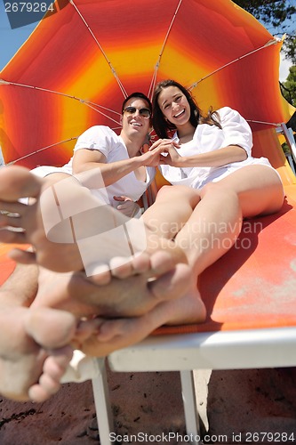 Image of happy couple have fun on the beach