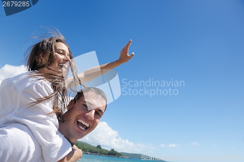 Image of happy couple have fun on the beach