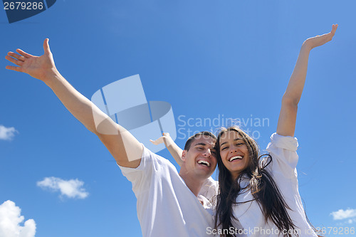 Image of happy couple have fun on the beach