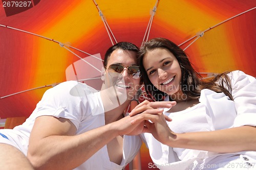 Image of happy couple have fun on the beach