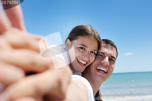 Image of happy couple have fun on the beach