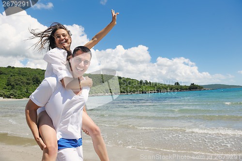 Image of happy couple have fun on the beach