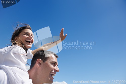 Image of happy couple have fun on the beach