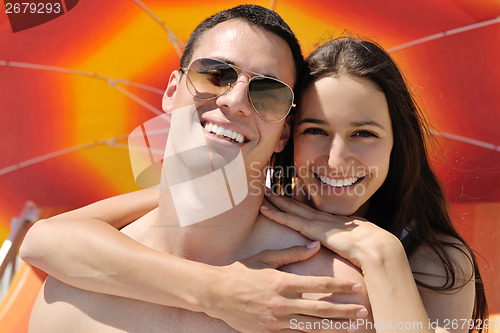 Image of happy couple have fun on the beach