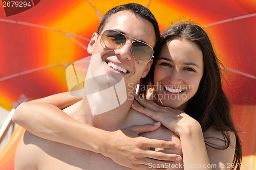 Image of happy couple have fun on the beach