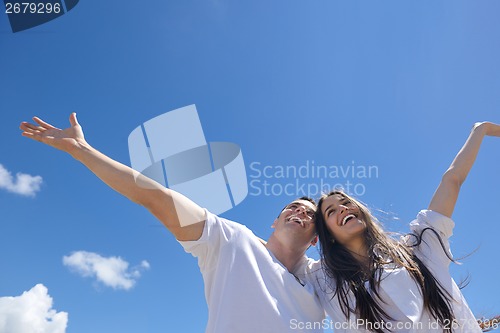 Image of happy couple have fun on the beach