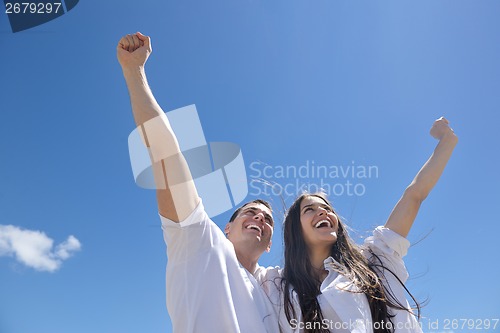 Image of happy couple have fun on the beach
