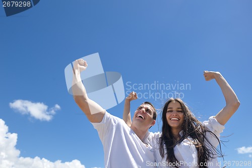 Image of happy couple have fun on the beach