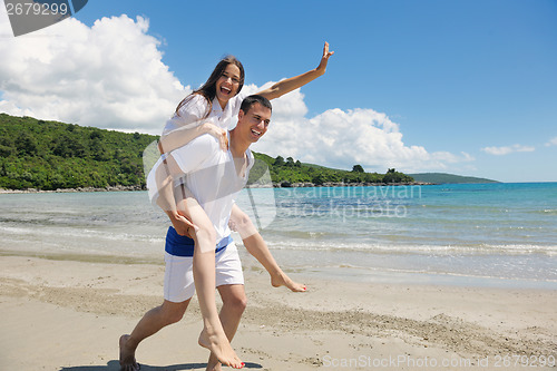 Image of happy couple have fun on the beach