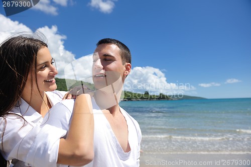 Image of happy couple have fun on the beach