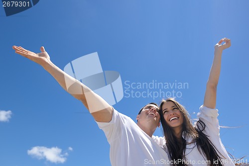 Image of happy couple have fun on the beach