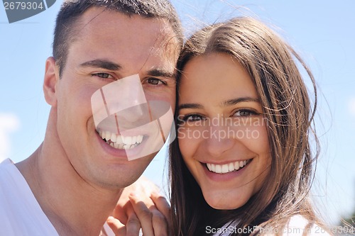 Image of happy couple have fun on the beach