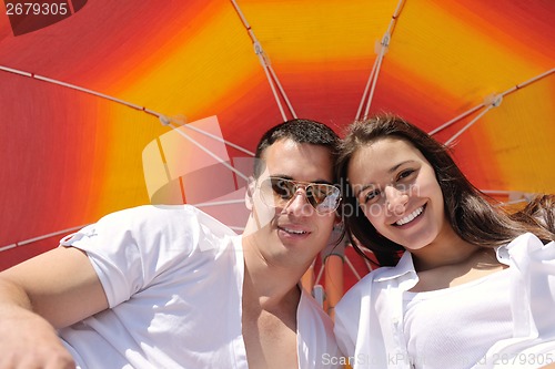 Image of happy couple have fun on the beach