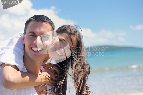 Image of happy couple have fun on the beach