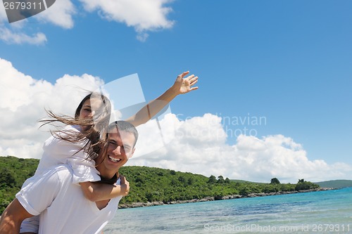 Image of happy couple have fun on the beach