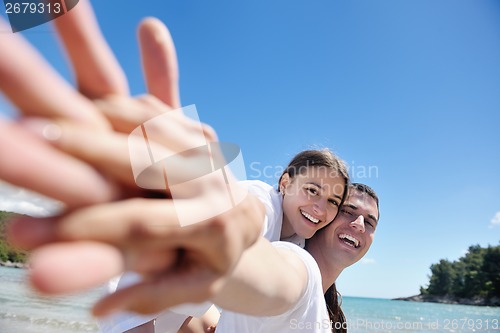 Image of happy couple have fun on the beach