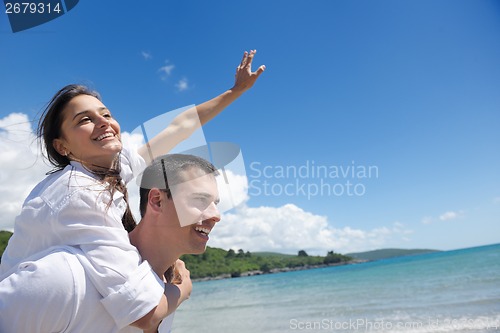 Image of happy couple have fun on the beach