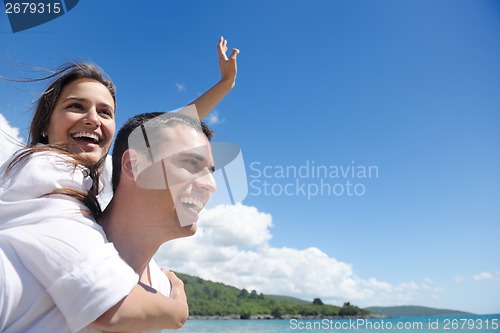 Image of happy couple have fun on the beach