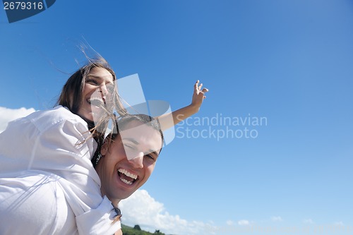 Image of happy couple have fun on the beach