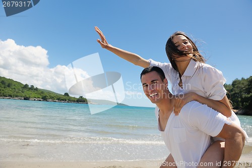 Image of happy couple have fun on the beach