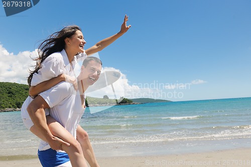 Image of happy couple have fun on the beach