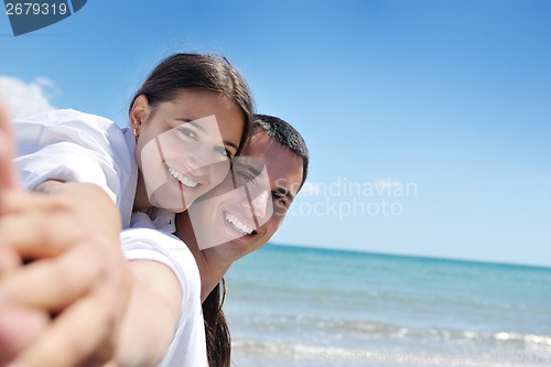 Image of happy couple have fun on the beach