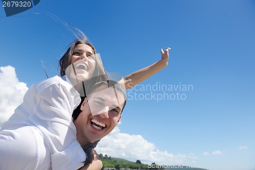 Image of happy couple have fun on the beach